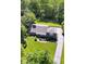 Well-manicured landscaping surrounding this lovely home featuring a spacious driveway and private backyard at 7035 Creekside Ln, Indianapolis, IN 46220