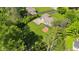 Expansive yard featuring mature trees, a large patio, and a charming sunroom, ideal for outdoor living at 7035 Creekside Ln, Indianapolis, IN 46220