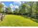 Expansive backyard enclosed by a wooden fence, featuring a well-maintained lawn at 7035 Creekside Ln, Indianapolis, IN 46220