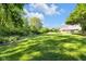 Well-maintained backyard with lush greenery and mature trees creating a serene, private outdoor space at 7035 Creekside Ln, Indianapolis, IN 46220