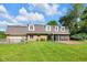Lush backyard with manicured lawn, screened in porch and well-maintained property, perfect for outdoor activities at 7035 Creekside Ln, Indianapolis, IN 46220