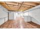 Unfinished basement featuring tiled flooring, painted cinder block walls, and exposed ceiling at 7035 Creekside Ln, Indianapolis, IN 46220