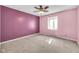 This bedroom is painted with pink and light-pink walls, features a ceiling fan and carpeted floors at 7035 Creekside Ln, Indianapolis, IN 46220
