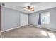 The bedroom has neutral walls, carpeted floors, and a ceiling fan for added comfort at 7035 Creekside Ln, Indianapolis, IN 46220