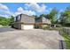 Expansive driveway provides ample parking space and leads to a charming home with garage and landscaping at 7035 Creekside Ln, Indianapolis, IN 46220