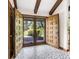 Inviting foyer with beautiful mosaic tile flooring and wooden double doors at 7035 Creekside Ln, Indianapolis, IN 46220