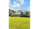 Landscaped front yard showcases a charming home with mature landscaping, flowering plants, and an inviting curb appeal at 7035 Creekside Ln, Indianapolis, IN 46220