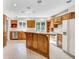 Classic kitchen with wood cabinets, center island with seating, and bright natural light from the garden window at 7035 Creekside Ln, Indianapolis, IN 46220