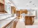 Kitchen with wood cabinets, stainless steel dishwasher, and a functional layout with ample natural light at 7035 Creekside Ln, Indianapolis, IN 46220