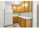 Compact kitchen with wood cabinets, white countertops, and appliances, maximizing space with efficient design at 7035 Creekside Ln, Indianapolis, IN 46220