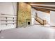 Bright and airy living room featuring a brick fireplace, wood beams, and staircase at 7035 Creekside Ln, Indianapolis, IN 46220