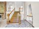 Spacious foyer features an elegant wooden staircase with white railings at 7035 Creekside Ln, Indianapolis, IN 46220