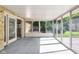 Relaxing sunroom with glass doors and windows overlooking the private backyard and patio at 7035 Creekside Ln, Indianapolis, IN 46220