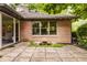 Paver patio with brick home and small koi pond in the backyard at 7887 Meadowbrook Dr, Indianapolis, IN 46240