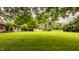 Expansive backyard with lush green lawn, mature trees, and access to the house at 7887 Meadowbrook Dr, Indianapolis, IN 46240