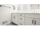 Modern bathroom with double vanity featuring sleek white cabinetry and black hardware at 7887 Meadowbrook Dr, Indianapolis, IN 46240