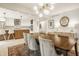 Open-concept dining room with kitchen view, wooden table, and modern light fixture at 7887 Meadowbrook Dr, Indianapolis, IN 46240