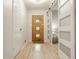 Bright entryway with wooden front door with glass panes, hardwood floor, and white trim at 7887 Meadowbrook Dr, Indianapolis, IN 46240