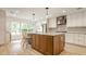 Bright kitchen featuring a large island, stainless steel appliances, and light wood floors at 7887 Meadowbrook Dr, Indianapolis, IN 46240