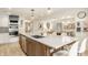 Open kitchen with large island, stainless steel appliances, and adjacent dining area at 7887 Meadowbrook Dr, Indianapolis, IN 46240