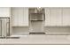 Bright kitchen with white cabinets, large island, and stainless steel appliances at 7887 Meadowbrook Dr, Indianapolis, IN 46240