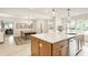 Open kitchen with island, stainless dishwasher, and view into the dining area at 7887 Meadowbrook Dr, Indianapolis, IN 46240