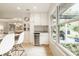 Bright kitchen nook with a wine fridge, sink, and window showcasing the exterior view at 7887 Meadowbrook Dr, Indianapolis, IN 46240