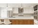 Bright kitchen featuring a large island, stainless steel appliances, and light wood floors at 7887 Meadowbrook Dr, Indianapolis, IN 46240