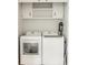 Laundry room with open cabinets and modern washer and dryer at 7887 Meadowbrook Dr, Indianapolis, IN 46240