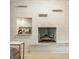 Bright living room featuring painted brick fireplace with wood beam mantel and a built-in bar at 7887 Meadowbrook Dr, Indianapolis, IN 46240