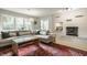 Comfortable living room with a fireplace, large sectional sofa, and view of the backyard at 7887 Meadowbrook Dr, Indianapolis, IN 46240