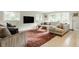 Spacious living room with large windows, comfortable seating, and stylish area rug at 7887 Meadowbrook Dr, Indianapolis, IN 46240