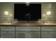 A built-in desk and media center feature ample storage and modern lighting fixtures at 7887 Meadowbrook Dr, Indianapolis, IN 46240
