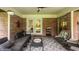 Cozy porch seating area with brick walls and overhead fan at 7887 Meadowbrook Dr, Indianapolis, IN 46240