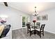 Dining room area with modern light fixture and sliding door to outdoor space at 8024 Sunfield Ct # 5-B, Indianapolis, IN 46214