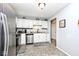 Bright kitchen with stainless steel appliances and white cabinets at 8024 Sunfield Ct # 5-B, Indianapolis, IN 46214