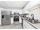 Kitchen featuring stainless steel appliances and white cabinets with tile backsplash at 8024 Sunfield Ct # 5-B, Indianapolis, IN 46214