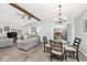 Cozy living room featuring wood beams, a ceiling fan, and a sliding door to outdoor space at 8024 Sunfield Ct # 5-B, Indianapolis, IN 46214