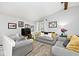 Comfortable living room with modern decor, soft gray sofas, and ample natural light at 8024 Sunfield Ct # 5-B, Indianapolis, IN 46214