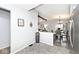 Open-concept living area with view to dining area and living room with beamed ceilings at 8024 Sunfield Ct # 5-B, Indianapolis, IN 46214