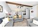 Open-concept living area featuring beam ceilings, plank floors, and plenty of natural light at 8024 Sunfield Ct # 5-B, Indianapolis, IN 46214
