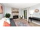 Comfortable living room featuring a stone fireplace, patio door, and stylish decor at 8024 Sunfield Ct # 5-B, Indianapolis, IN 46214