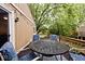 Inviting back patio with a metal table, comfortable seating, and decorative string lights at 8024 Sunfield Ct # 5-B, Indianapolis, IN 46214