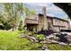 Home featuring a spacious deck overlooking a well-manicured lawn and mature trees at 8024 Sunfield Ct # 5-B, Indianapolis, IN 46214