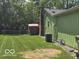 Spacious backyard with lush green lawn, a storage shed, and a fenced perimeter for privacy at 8206 Bull Run Ct, Indianapolis, IN 46227