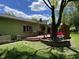 Backyard view showcasing the deck, mature tree, exterior paint color, and lawn at 8206 Bull Run Ct, Indianapolis, IN 46227