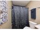 Cozy bathroom featuring a dark shower curtain and neutral wall paint at 8206 Bull Run Ct, Indianapolis, IN 46227