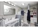 Well-lit bathroom with a vanity, mirror, and shower with glass doors at 8206 Bull Run Ct, Indianapolis, IN 46227