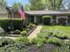 Inviting home entrance, enhanced by a well-manicured garden and an American flag at 8206 Bull Run Ct, Indianapolis, IN 46227