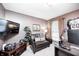 Cozy living room features a comfortable leather loveseat, TV, and neutral decor at 8206 Bull Run Ct, Indianapolis, IN 46227